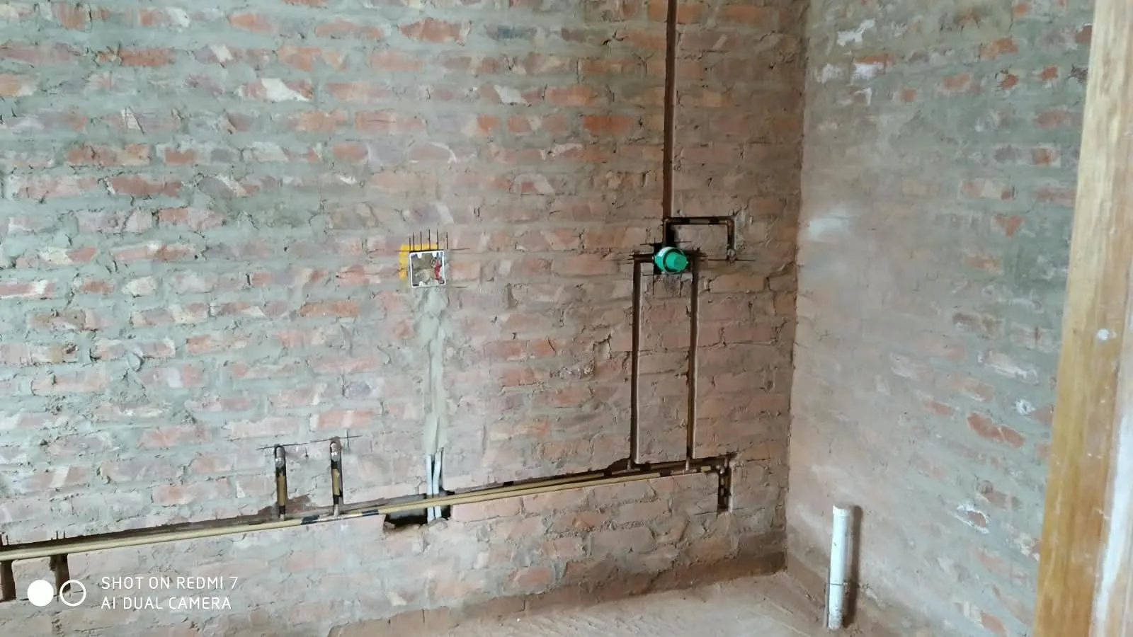 Copper and brass plumbing pipework chased into brickwork by H.B. Plumbing
