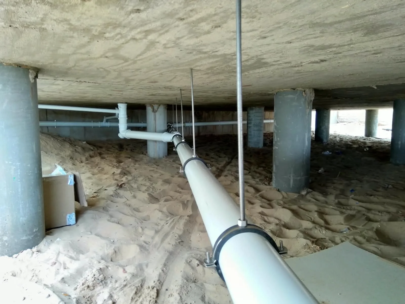 Suspended drainage pipework installed under a raised concrete slab by H.B. Plumbing